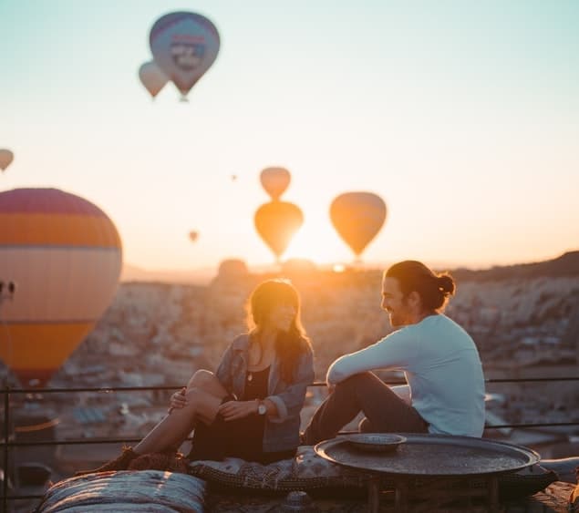 Dachterrasse mit Blick über die Stadt und Fesselballons am Himmel