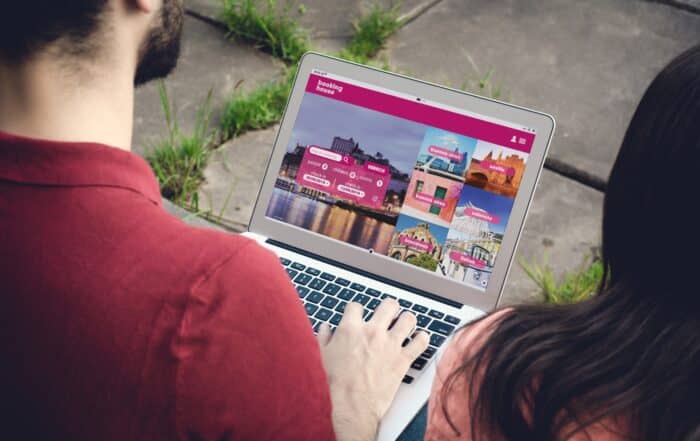 Man with laptop booking a hotel on website