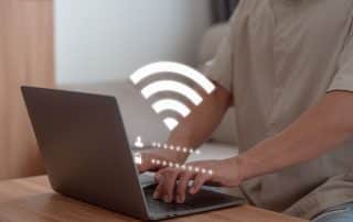 User man searching and connect for wifi on his a computer laptop in the hotel. Concept of technology connectivity and connection problems to wifi by computer.