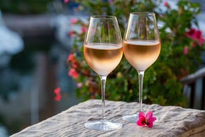 Tasting of local rose wine in summer with sail boats haven of Port Grimaud on background, Provence, France Tasting of local rose wine in summer with sail boats haven of Port Grimaud on background, Provence, France