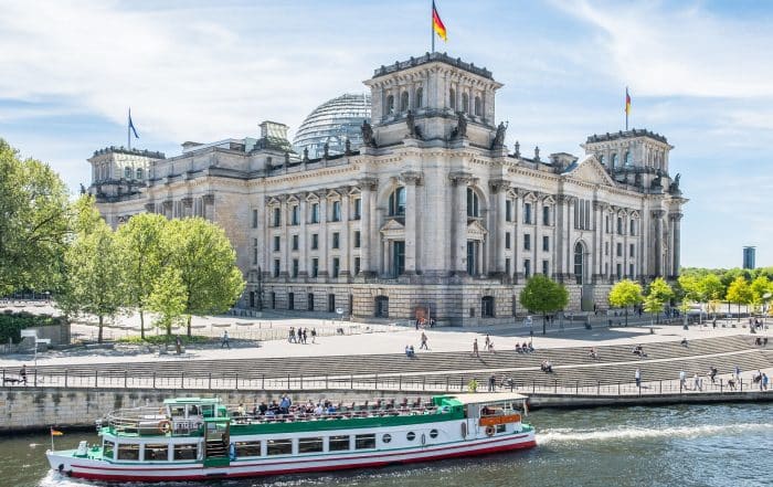 Tourist boat at German Reichtag building at government district in Berlin