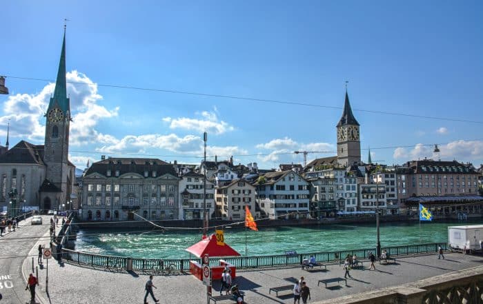 The Fraümunster and the Predigerkirche by Limmat River in Zurich Old Town - Switzerland