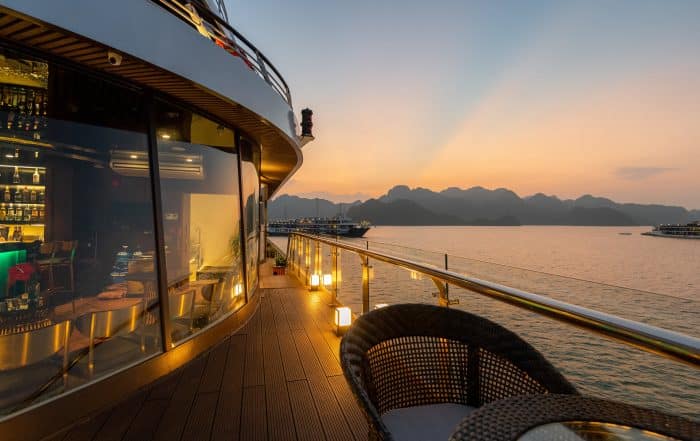 5 Star luxury on new modern Cruise Ships on Ha Long Bay, Vietnam looking over the stunning limestone rocks at Sunset