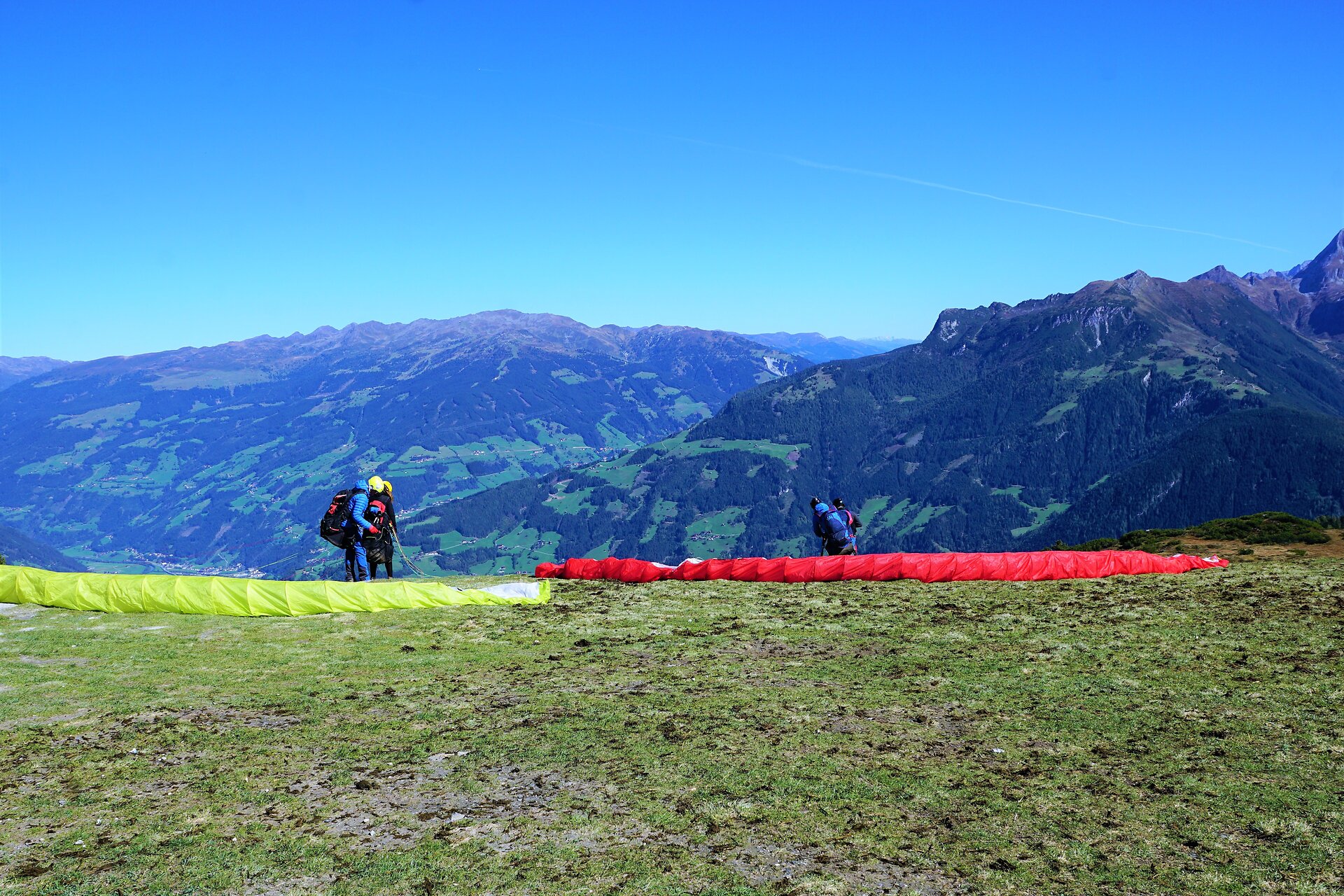 Paraglider bereiten sich auf den Start vor in den Zillertaler Bergen in Österreich