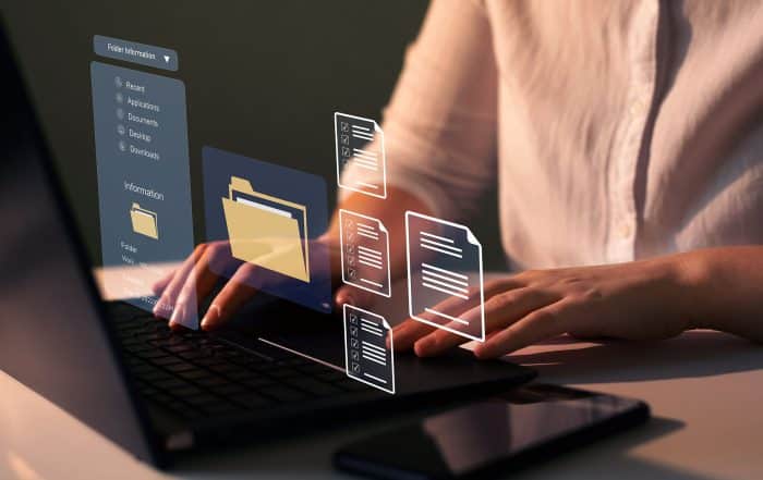 Businesswoman working on laptop with virtual screen.