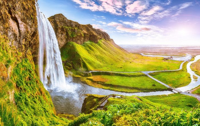 Beautiful Seljalandsfoss waterfall in Iceland during the sunset. Location: Seljalandsfoss waterfall, part of the river Seljalandsa, Iceland, Europe