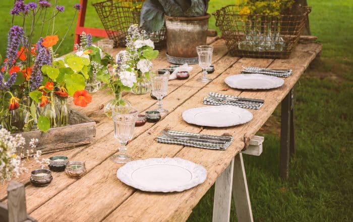 Wooden table setup for garden party or dinner reception.
