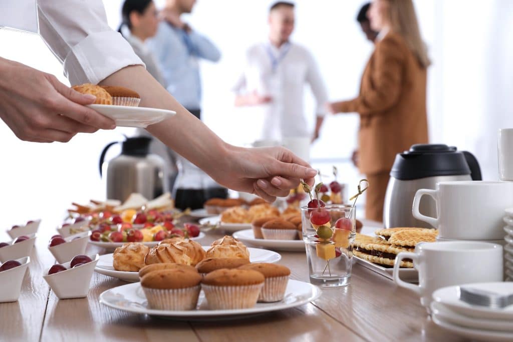 Woman taking snack during coffee break, closeup