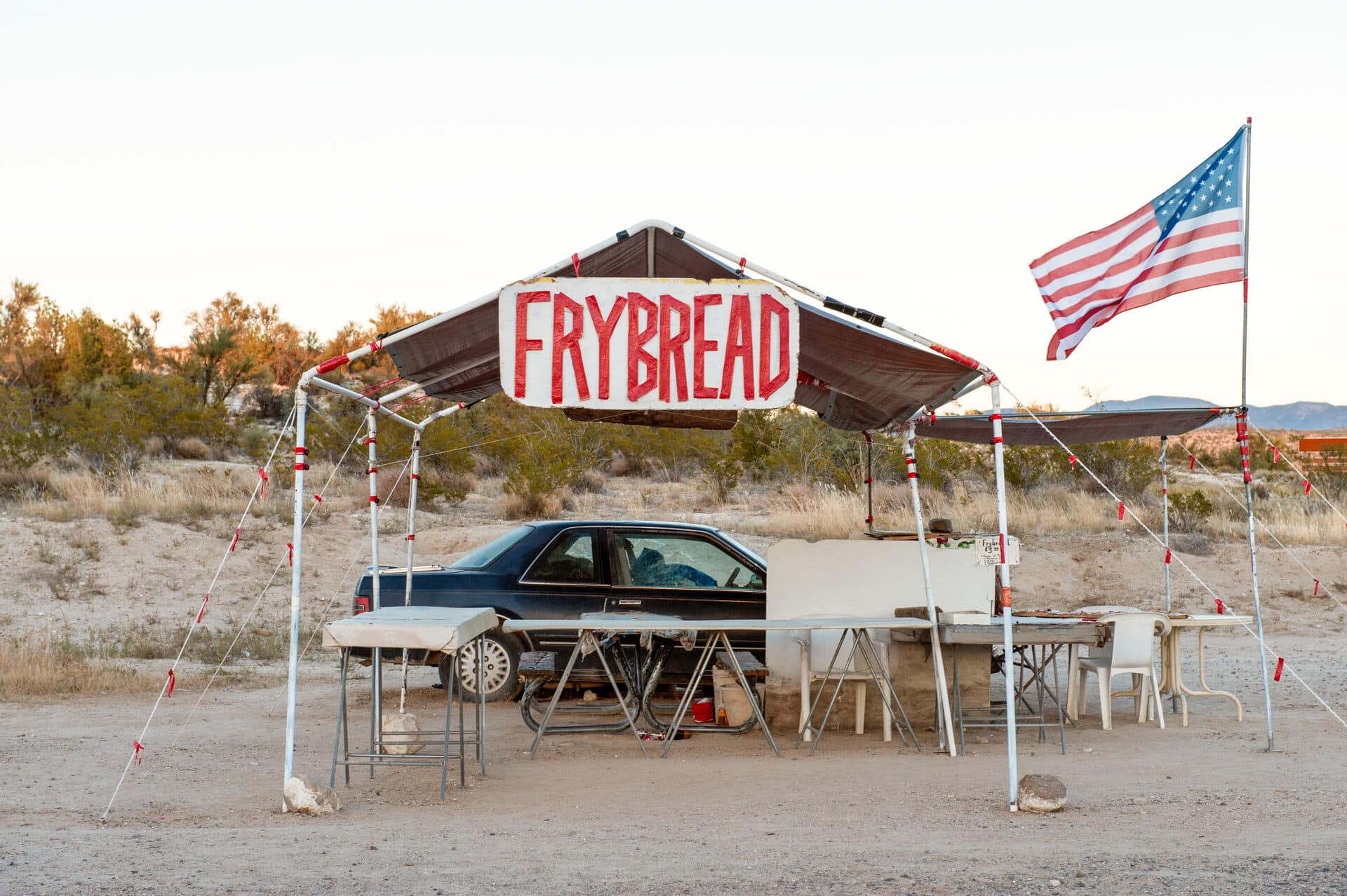 Native American Navajo frybread roadside stall with an American flag, Camp Verde, near Sedona, Arizona, US